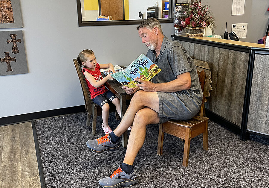 Mr. Ron reading a book to ECE student
