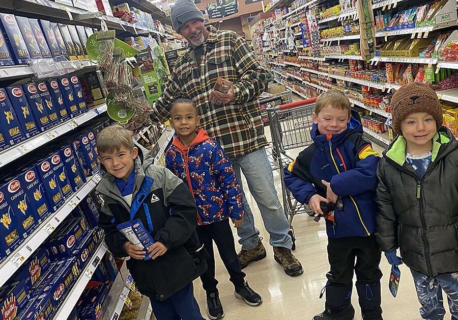 FRCS kindergarten students shop with Mr. Ron for Food Drive goods